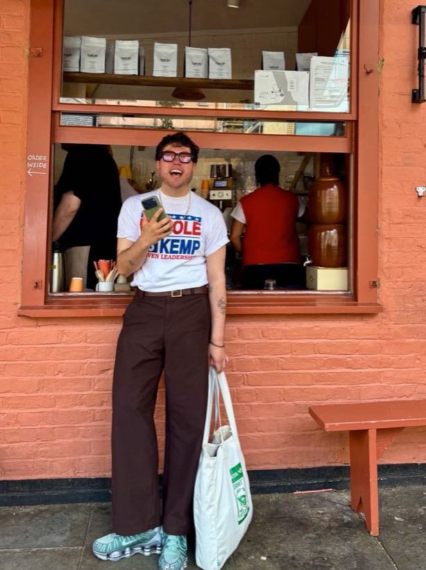Sebastian laughing outside a coffee window