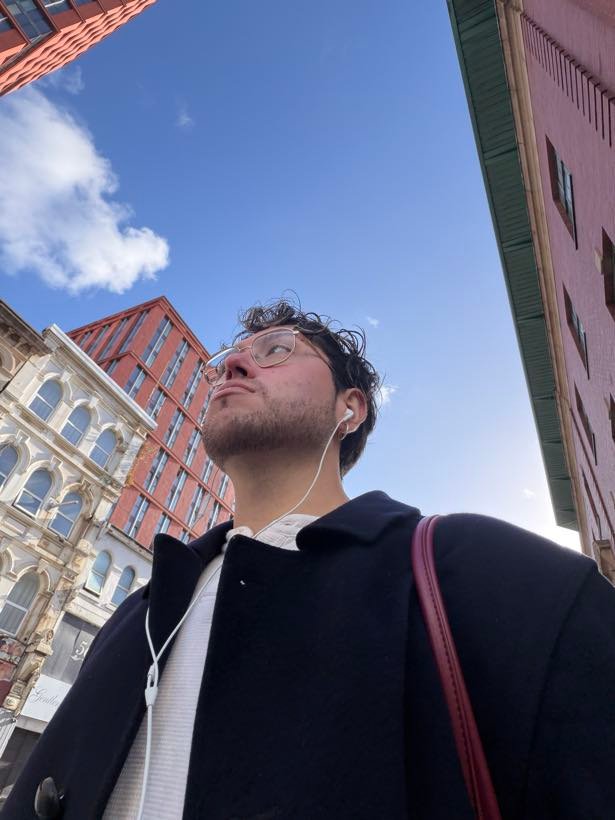 Sebastian on a Manchester street, looking up